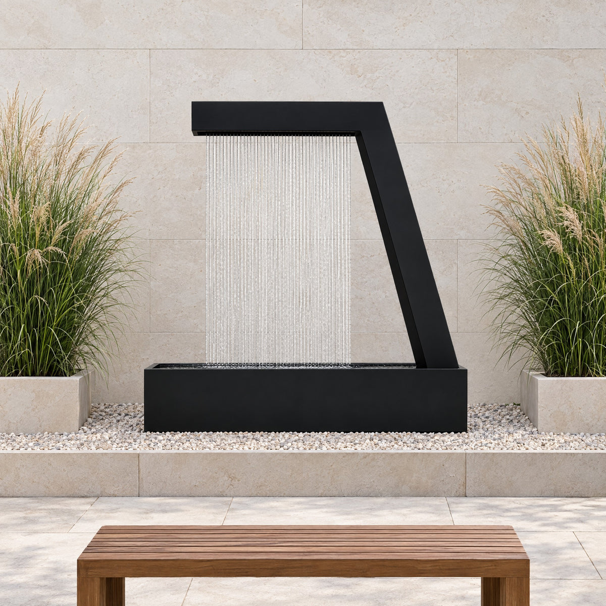 Black steel Zura Flow rain curtain fountain in a gravel bed against a limestone wall with ornamental grasses